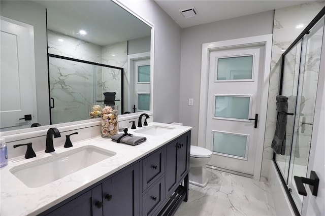 bathroom with vanity, an enclosed shower, and toilet