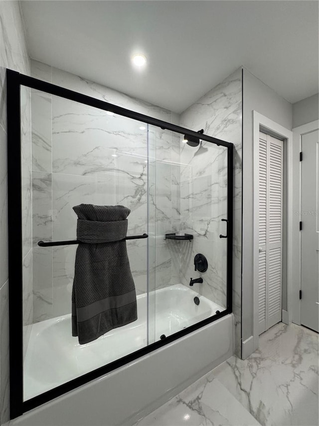 bathroom featuring bath / shower combo with glass door