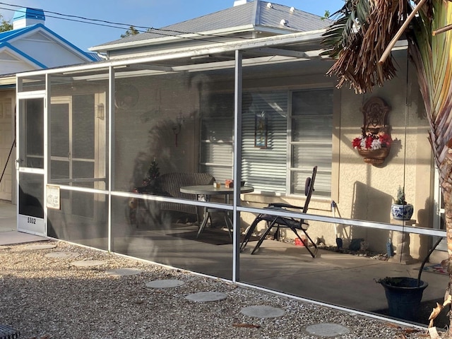 view of patio with a sunroom