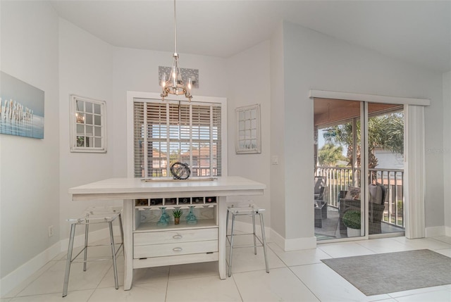 dining area with light tile patterned floors and a notable chandelier