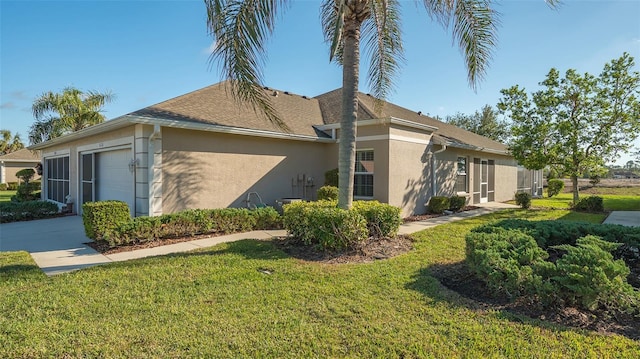 view of side of home with a lawn and a garage