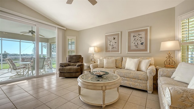 living room with light tile patterned floors, ceiling fan, and lofted ceiling