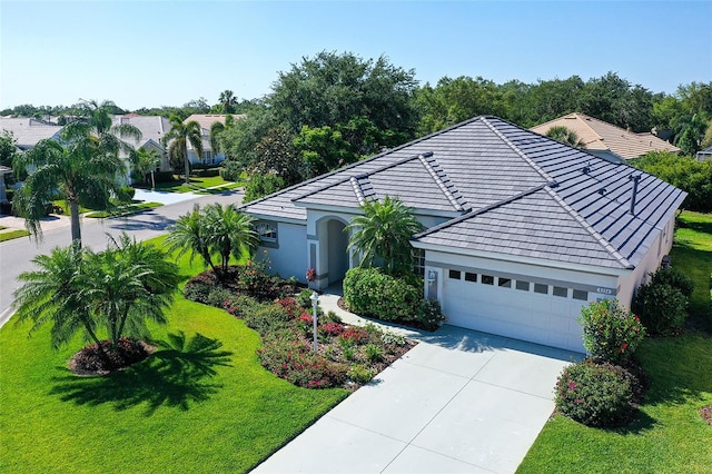 8334 Sailing Loop, Lakewood Ranch, FL 34202 - view of front of property featuring concrete driveway, a garage, a front lawn, and stucco siding