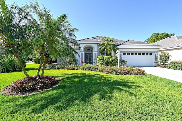 view of front of home featuring a front yard and a garage