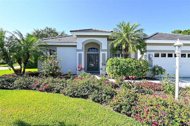8334 Sailing Loop, Lakewood Ranch, FL 34202 - view of front of house featuring a garage, stucco siding, a tiled roof, and a front yard