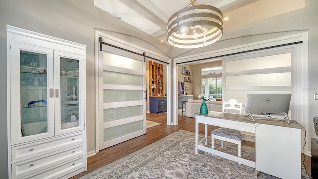 office space with hardwood / wood-style floors, a barn door, and a notable chandelier