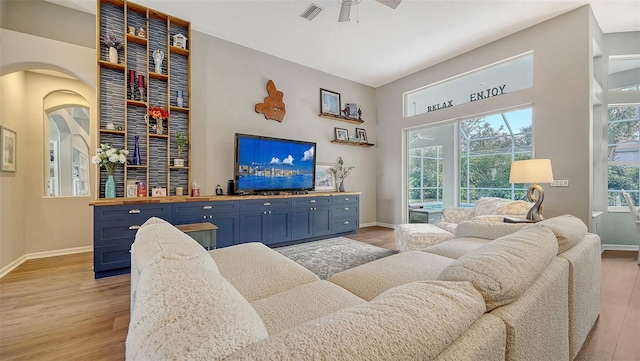 8334 Sailing Loop, Lakewood Ranch, FL 34202 - living area featuring light wood finished floors, a ceiling fan, and arched walkways
