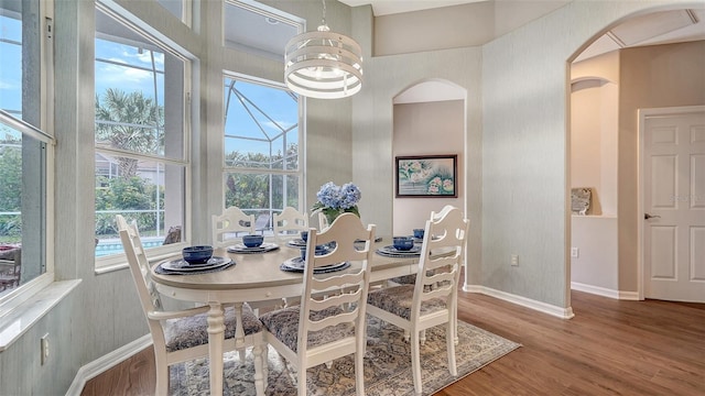 8334 Sailing Loop, Lakewood Ranch, FL 34202 - dining area with wood finished floors and arched walkways