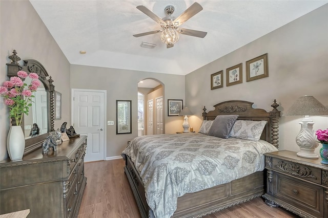 8334 Sailing Loop, Lakewood Ranch, FL 34202 - bedroom featuring arched walkways, a closet, light wood-style floors, and a ceiling fan