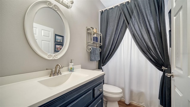 bathroom featuring curtained shower, hardwood / wood-style floors, vanity, and toilet