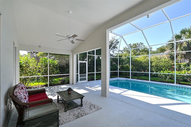 view of pool with a lanai, ceiling fan, and a patio area