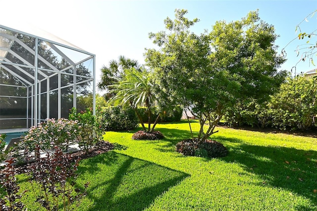 view of yard featuring glass enclosure