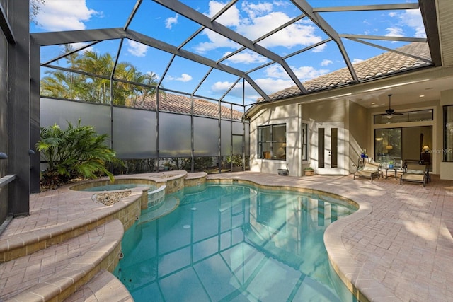 view of pool with an in ground hot tub, glass enclosure, ceiling fan, and a patio area