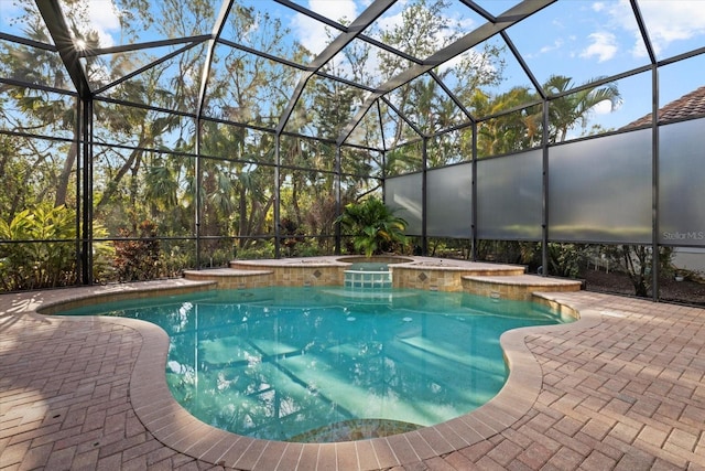 view of pool featuring a patio area, a lanai, and an in ground hot tub