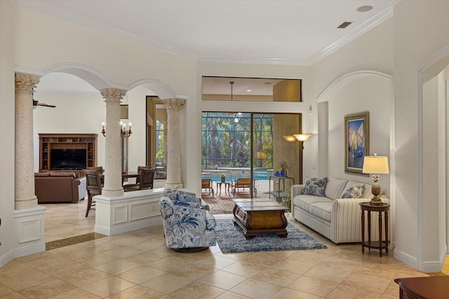 tiled living room with decorative columns and crown molding