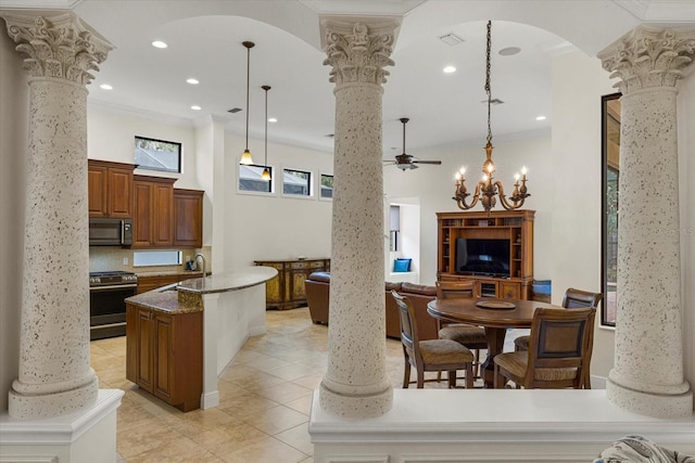 kitchen with decorative columns, decorative light fixtures, and appliances with stainless steel finishes