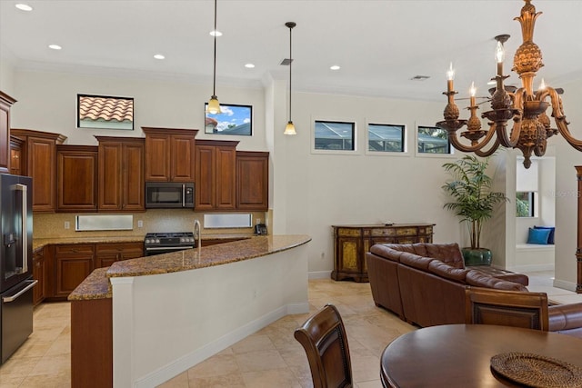 kitchen featuring crown molding, hanging light fixtures, stone counters, and stainless steel appliances