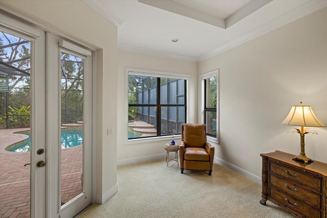 sitting room featuring light colored carpet, crown molding, and french doors