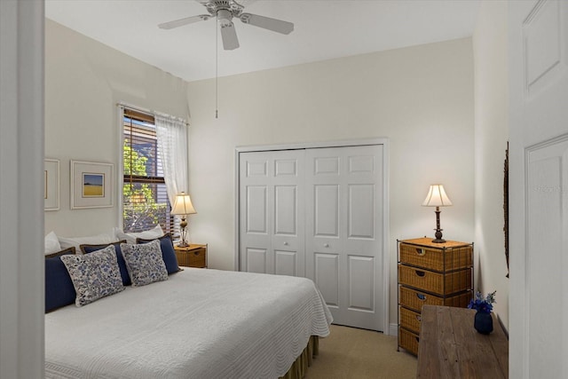 carpeted bedroom featuring ceiling fan and a closet