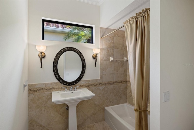 bathroom featuring shower / bath combo and tile walls