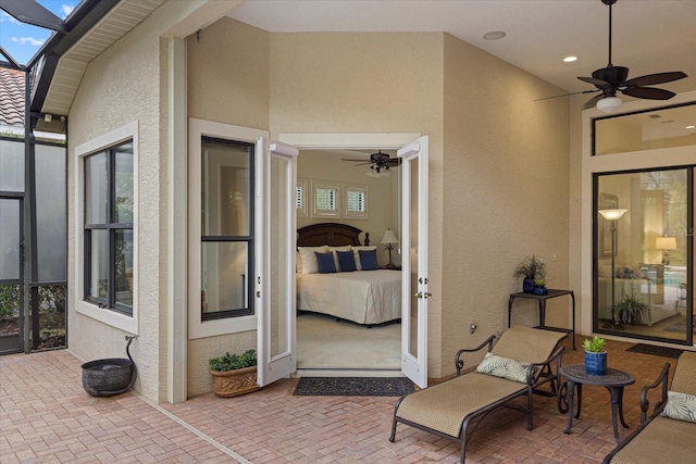 view of patio / terrace featuring ceiling fan and a lanai