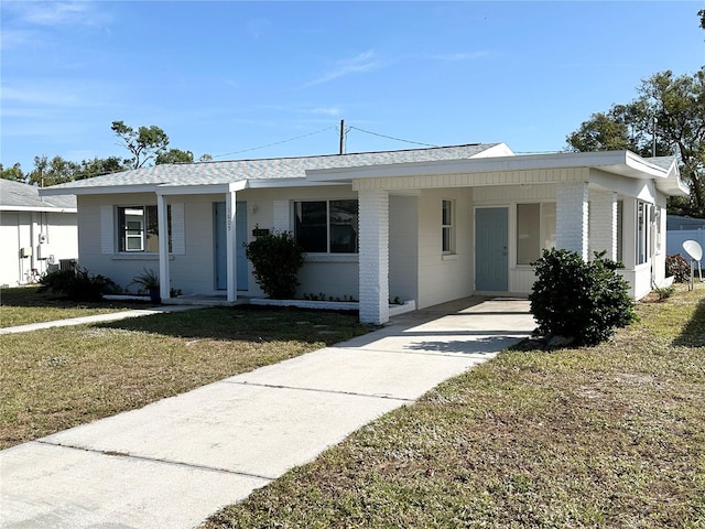 single story home with a carport and a front lawn