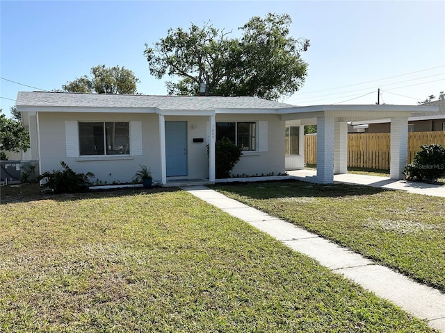 ranch-style house with a front lawn and a carport