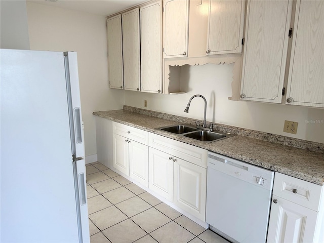 kitchen with light tile patterned floors, white appliances, and sink