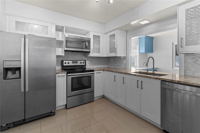 kitchen featuring white cabinetry, sink, decorative backsplash, and appliances with stainless steel finishes