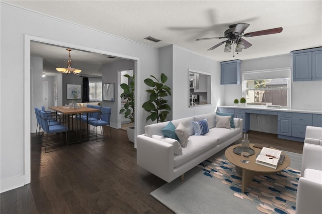 living room featuring crown molding, ceiling fan with notable chandelier, a textured ceiling, and dark hardwood / wood-style flooring