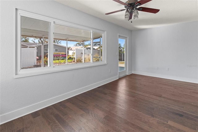 unfurnished room with dark wood-type flooring, plenty of natural light, and ceiling fan