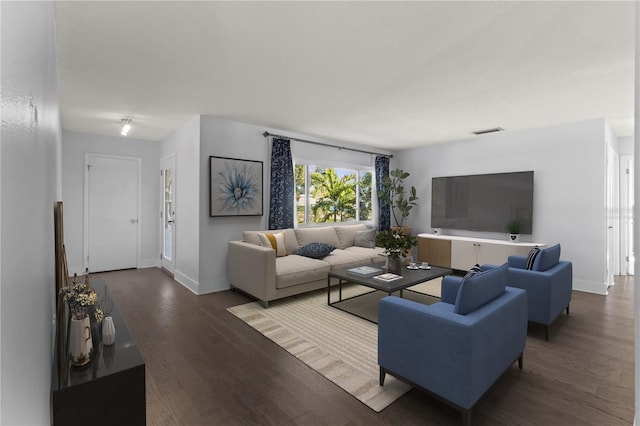 living room with baseboards, wood finished floors, and visible vents