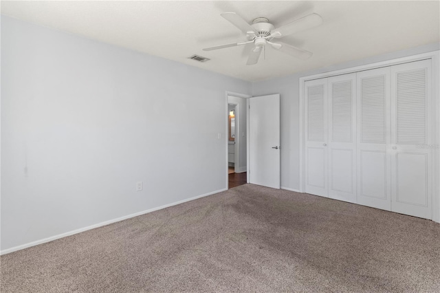 unfurnished bedroom with visible vents, a ceiling fan, carpet floors, a closet, and baseboards