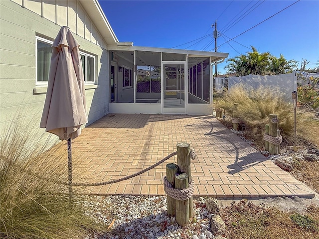 view of patio with a sunroom