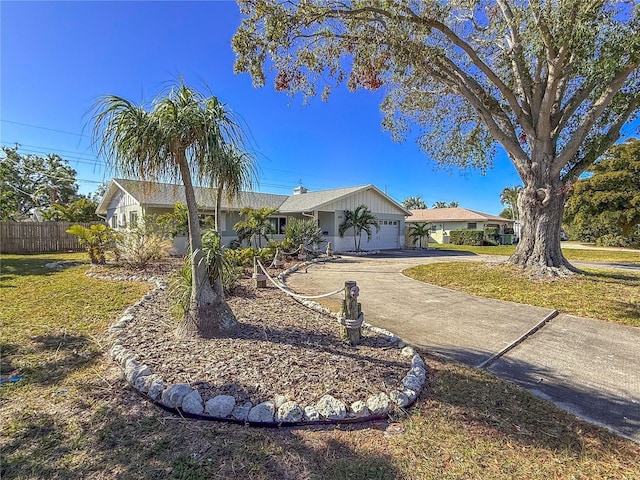 ranch-style house featuring concrete driveway, a front lawn, fence, and a garage