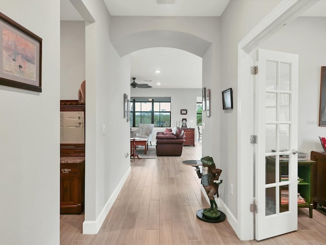 hallway with french doors and light wood-type flooring