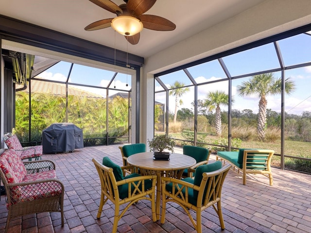 sunroom featuring ceiling fan