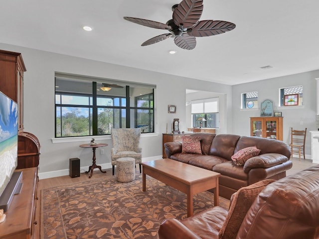 living room featuring ceiling fan and light hardwood / wood-style floors