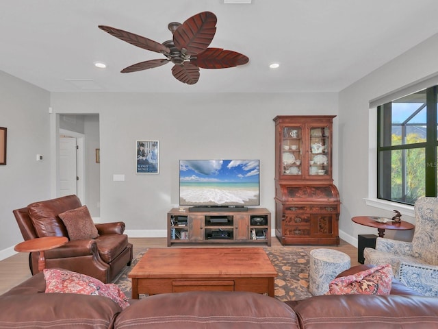 living room featuring hardwood / wood-style floors and ceiling fan