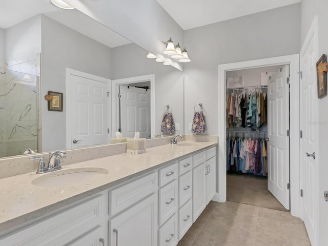 bathroom featuring tile patterned floors, a shower, and vanity