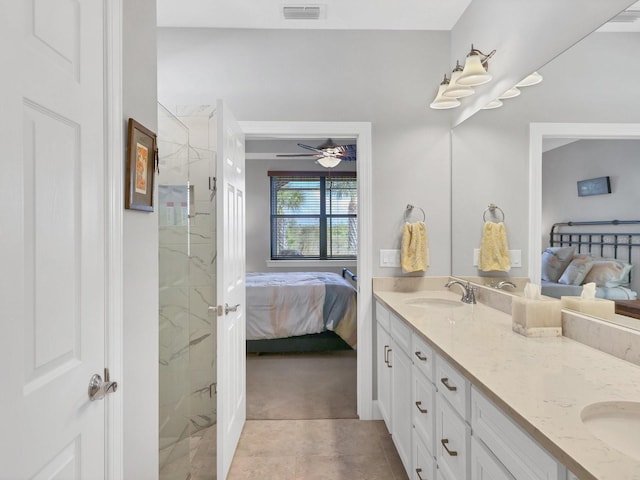 bathroom featuring ceiling fan, a shower with shower door, and vanity