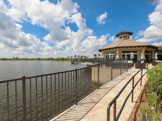 surrounding community with outdoor lounge area and a water view