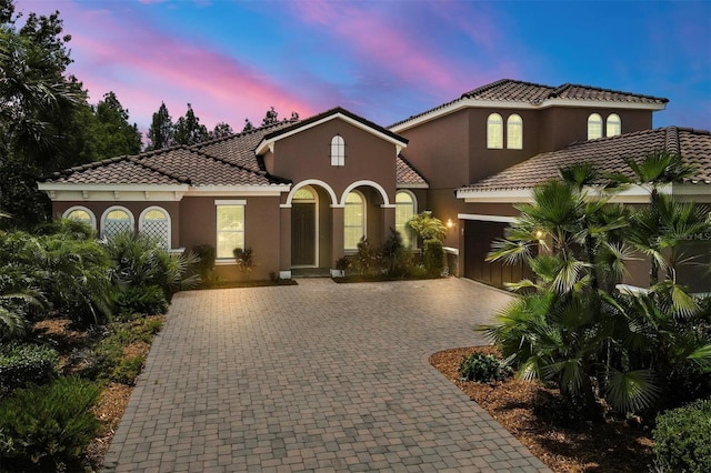 mediterranean / spanish-style house featuring a garage