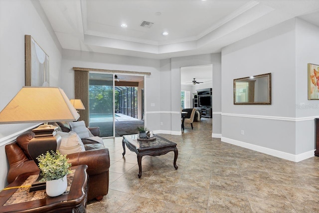 living room featuring crown molding and a tray ceiling