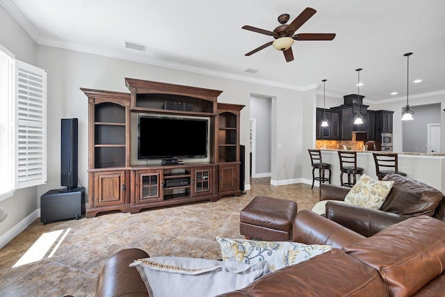 living room featuring ceiling fan and crown molding