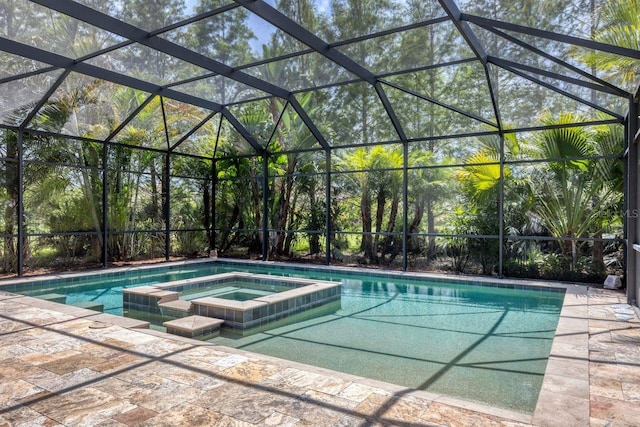 view of pool featuring a patio area, a lanai, and an in ground hot tub