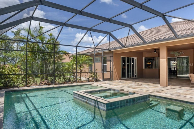 view of swimming pool featuring glass enclosure, ceiling fan, a patio area, and an in ground hot tub