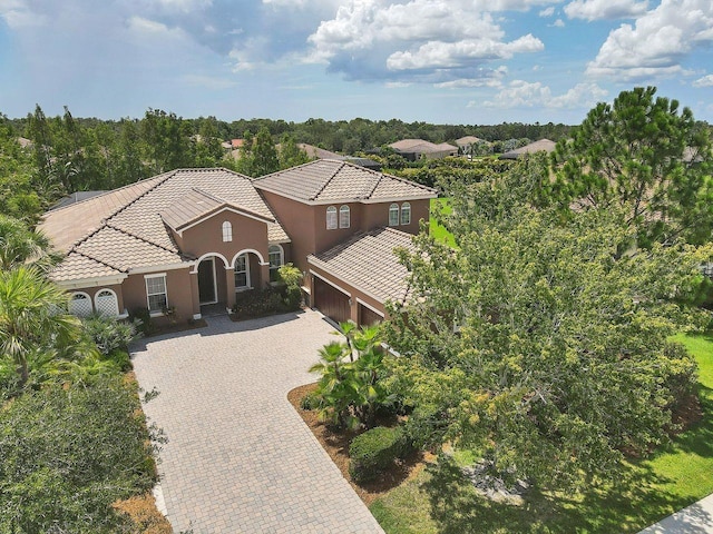 mediterranean / spanish-style house with a garage