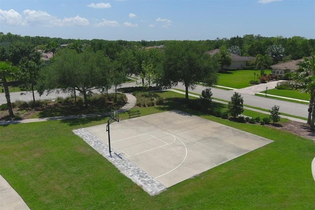 view of sport court with a lawn