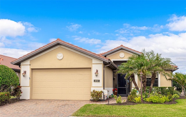 view of front of house featuring a garage and a front lawn